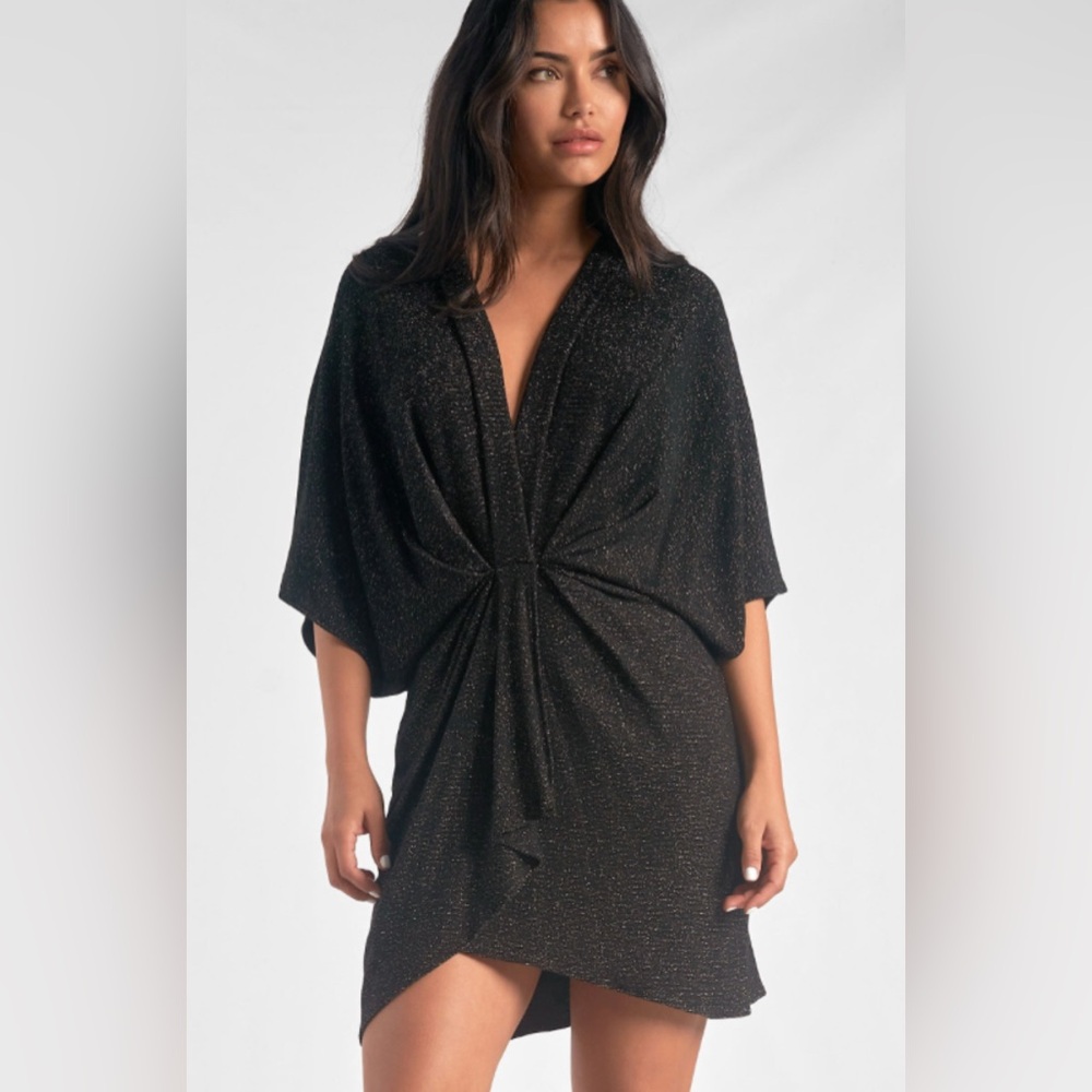 Elan mini wrap dress. Worn once. Size small. Black with gold stitch detail.